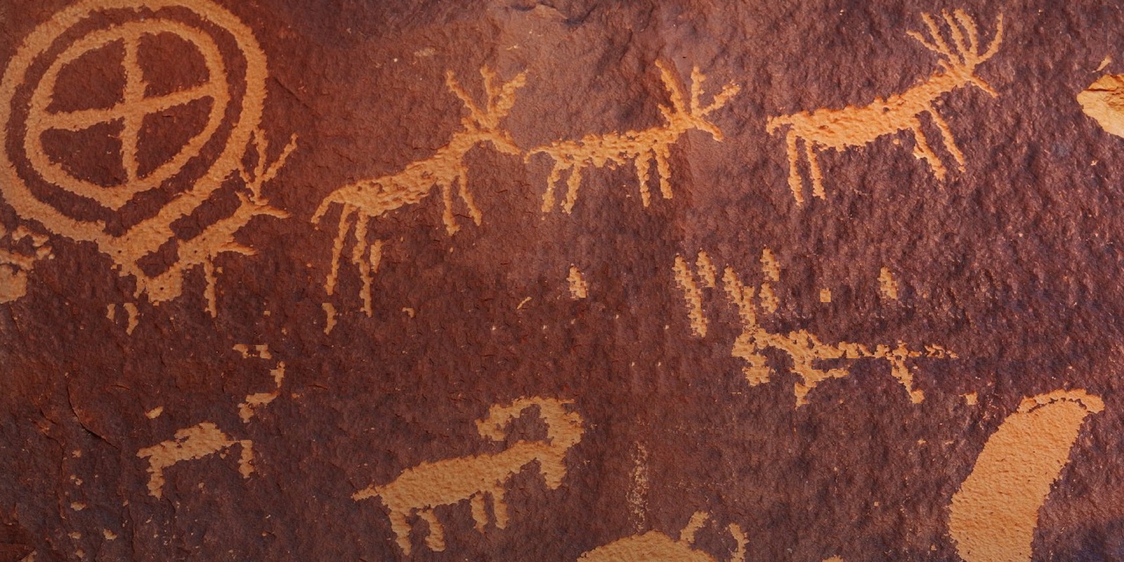 Ancient petroglyphs of deer, animals and a circular sun symbol carved into red sandstone, Living with Reality Ep. 56 Ancestors